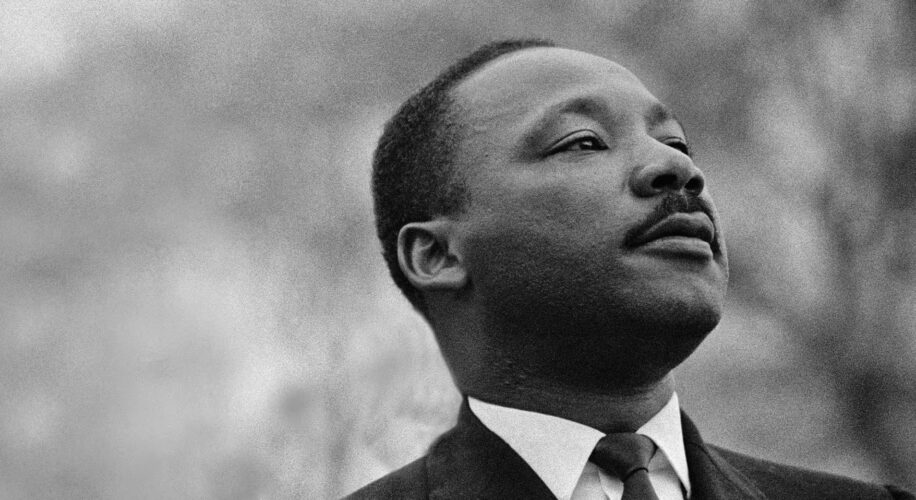 Portrait of Martin Luther King Jr. looking upward with a thoughtful expression.